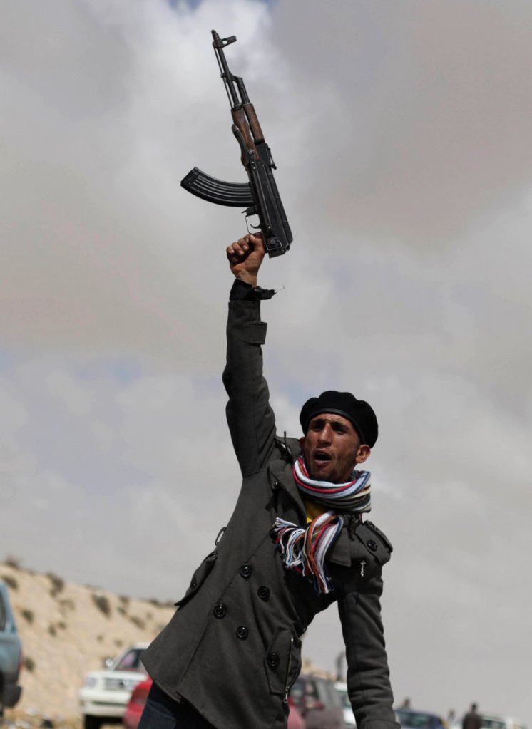 A Libyan rebel shouts religious slogans before heading toward the front line Saturday near Brega, Libya. The United States said it was ending its role in combat missions over the country Saturday, turning the task over to other nations.