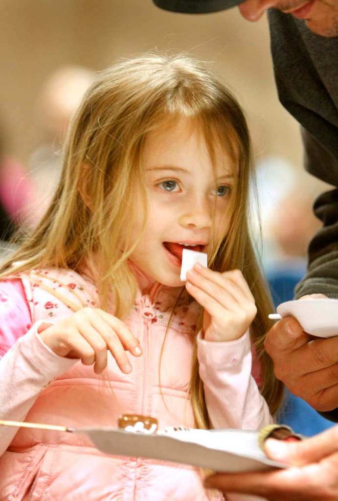 Gabriella Pecoraro Muehle, 5, of Gorham tries a taste of Lickable Wallpaper by Chocolate Falls in Maine.