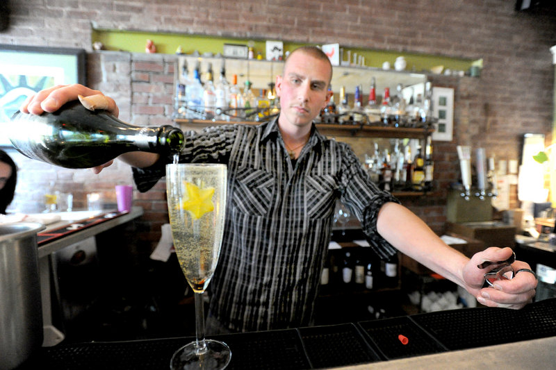 Kyle Miron mixes a house specialty drink called a Starfruit Sparkler at Figa in Portland.