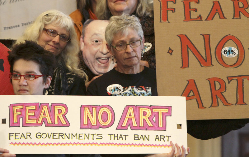 Demonstrators rally Monday at the State House, demanding the return of the mural that Gov. Paul LePage ordered removed from the Maine Department of Labor headquarters.