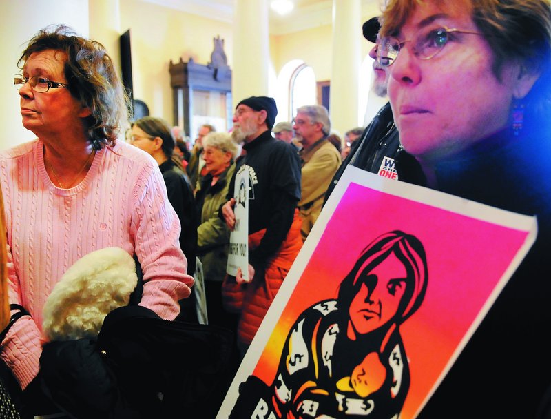 Demonstrators rally Monday at the State House. Portland City Councilor David Marshall said LePage “has taught us more about Maine’s labor history than we have ever known.”