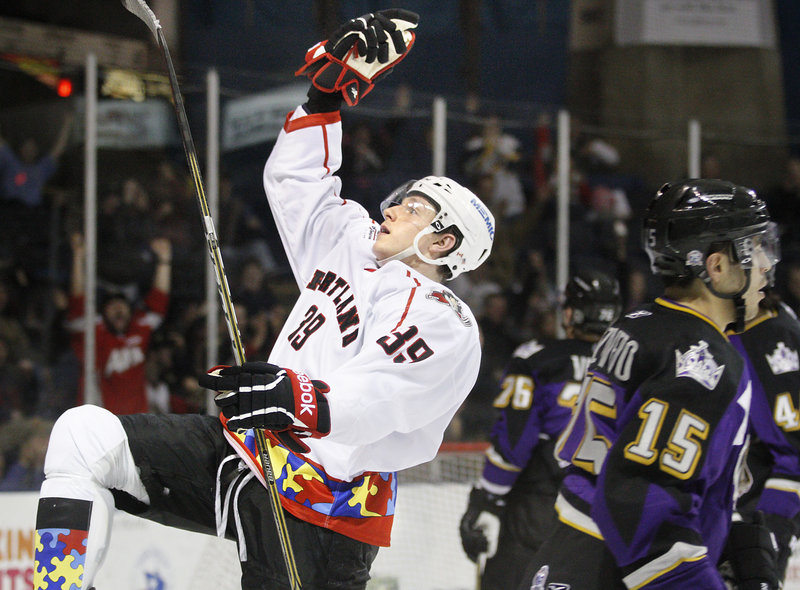 Luke Adam of the Pirates celebrates after scoring a power-play goal seven minutes into the third period. Adam also scored in overtime to give Portland a 6-5 victory Wednesday night over the Manchester Monarchs at the Civic Center.