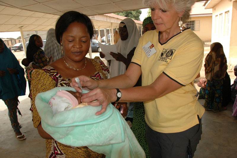 Ann Lee Hussey of South Berwick administers polio vaccine to an infant outside Kaduna Hospital in Nigeria as part of a Rotary International program.