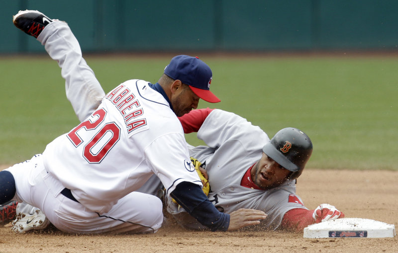 Darnell McDonald of the Red Sox reaches for the base, but not before Indians second baseman Orlando Cabrera tags him out to end the game. Cleveland won on a squeeze, 1-0.