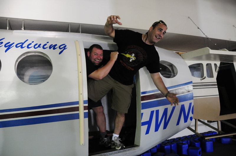Listen Up Español co-founders Craig Handley, left, and Tony Ricciardi ham it up after skydiving from a plane above Memphis. They belong to a membership company that organizes thrilling networking and team-building trips.