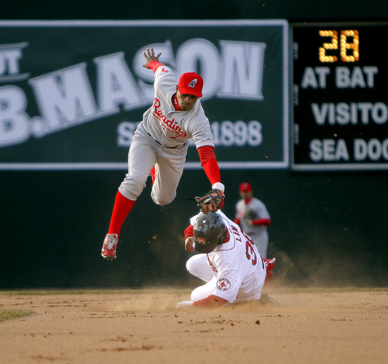 Che-Hsuan Lin of the Sea Dogs, bottom, beats the tag of the Phillies Harold Garcia in the first inning Friday night at Hadlock Field. Lin was stranded on base as the Sea Dogs went on to lose, 7-5.