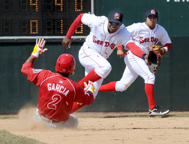 Sea Dogs second baseman Oscar Tejeda is backed up by shortstop Ryan Dent while lunging for a throw that's too late to prevent Reading's Harold Garcia from stealing second base.