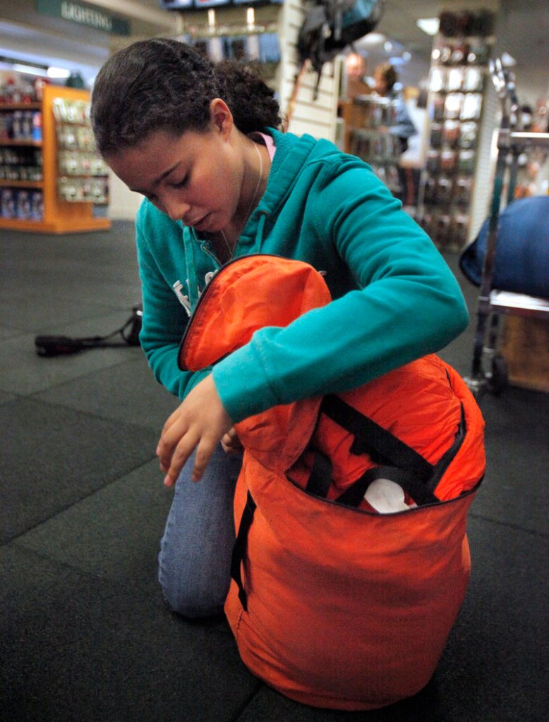 Portlander Reagan Brown, 9, stuffs a sleeping bag into its sack.