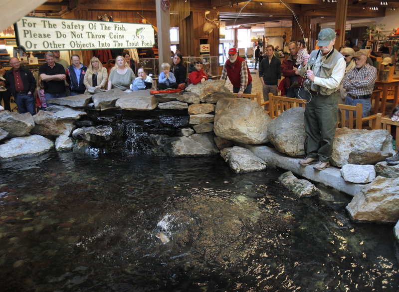 John Butler lands a brook trout during a fishing demonstration in the store.