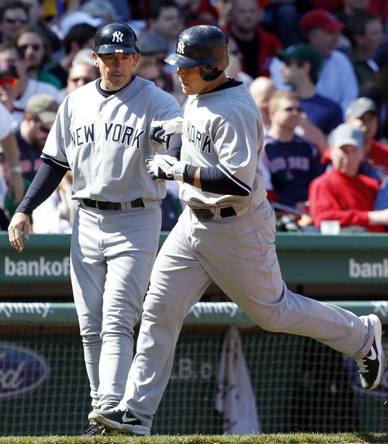 Russell Martin, who chose the Yankees over the Red Sox during the winter, is greeted by third-base coach Rob Thomson after hitting a three-run homer in the fourth inning Saturday.