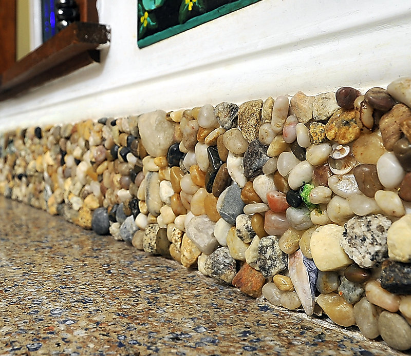 The backsplash in Amanda Edwards’ Falmouth kitchen is made from rocks, shells, sea glass and more that her children found on trips to the beach.