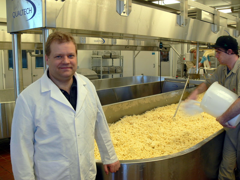 Mark Whitney oversees a run of cheddar at the Pineland Farms creamery.