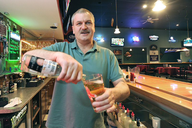 Bartender Mark Ross pours a beer at Club 302 in Windham, a huge gathering spot that's all about charitable causes and events, all the time. It has a scrolling lineup of live music, theater performances, banquets and receptions.