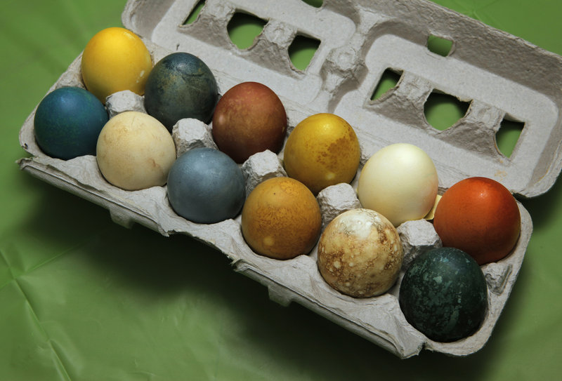 Variety pack: A dozen eggs in colors straight out of nature feature shells tinted with, back row, left to right, turmeric, blueberries, beets, green tea, oranges and yellow onion skins; front row, red cabbage, spinach, canned tart cherries in syrup, carrot tops, pomegranate juice and red cabbage.