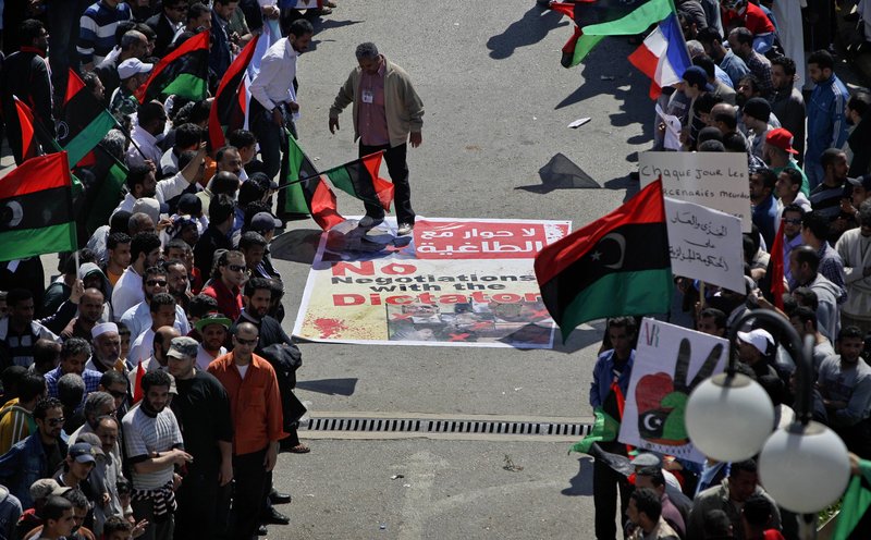 An angry but peaceful crowd lines the route to the Tibesty Hotel where an African Union delegation met with opposition leaders in Benghazi, Libya on Monday. Of Moammar Gadhafi, protester Jalil Tabouri said: "He is the biggest lier in the history of Libya."