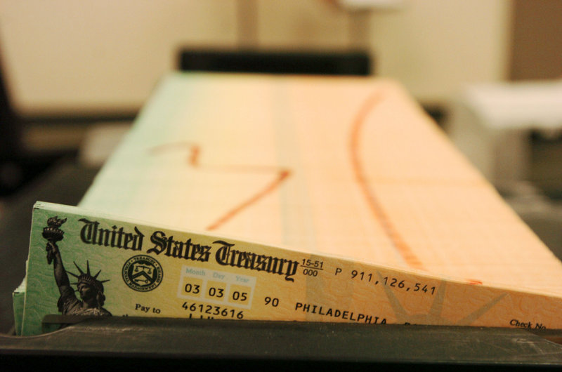Trays of Social Security checks await mailing at the U.S. Treasury. Despite political risks, President Obama is expected to propose adjustments to the program in order to cut debt.