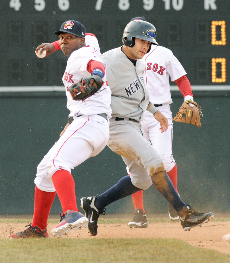 Oscar Tejeda of the Sea Dogs holds his throw to first after getting Austin Krum of the Thunder out at second Monday night at Hadlock Field. Portland opened its second homestand of the season with a 3-2 loss in 10 innings.