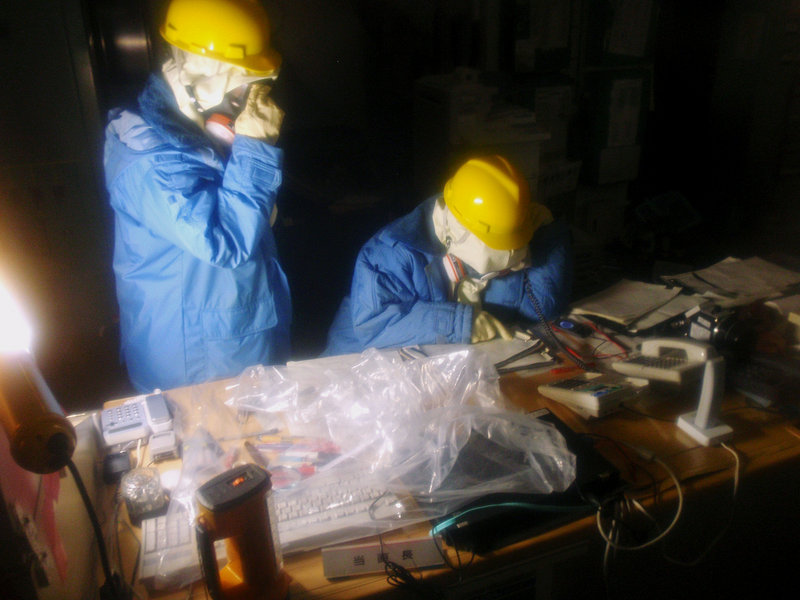 Tokyo Electric Power Co. workers collect data in the control room for Unit 1 and Unit 2 at the tsunami-crippled Fukushima Dai-ichi nuclear power plant in Fukushima, Japan.