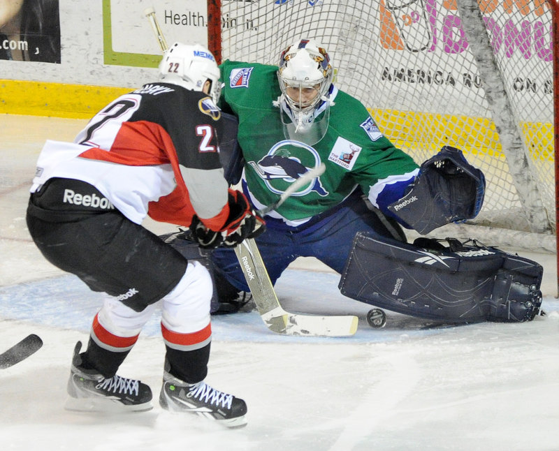 Igor Gongaisky of the Pirates looks for a rebound as Whale goalie Dov Grumet-Morris stops a shot during the Pirates’3-2 victory Thursday night in Game 1 of their playoff series.