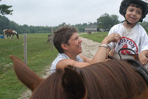 Samuel rides on Cosmic the horse with physical therapist Colleen Sullivan at Gelinas Farm in Pembroke, N.H.