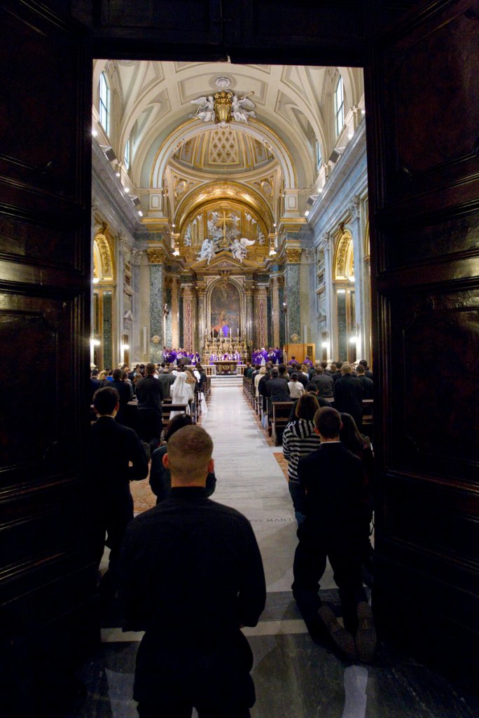 Mass in Sant’Apollinare, one of the ancient “station churches” in Rome, draws an overflow crowd on Thursday.