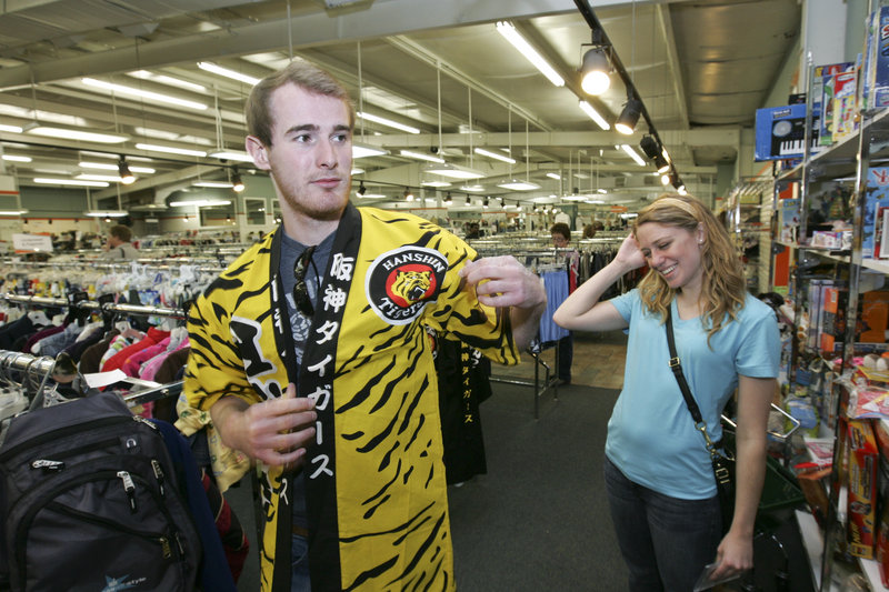 Auburn University student Ryan Little gets a laugh from his girlfriend, Jordan Haden, as he tries on a Hanshin Tigers gi that he found in the clothing aisles at Unclaimed Baggage Center in Scottsboro, Ala. The 40,000-square-foot store sells items from lost luggage, after airlines fail to locate the owners.