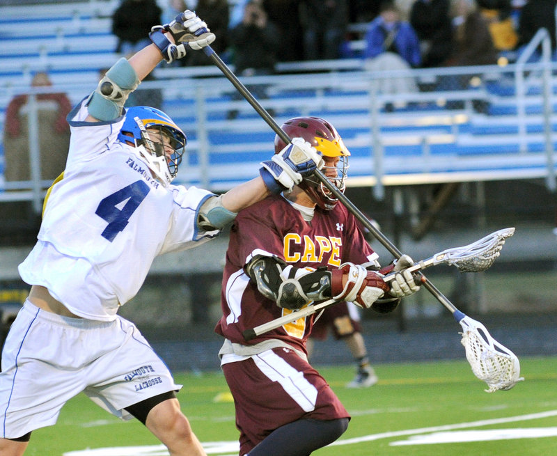 Mike Ryan of Falmouth makes an attempt to knock the ball away from Timmy Takach, who controls it for Cape Elizabeth.