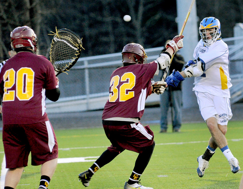Mitch Tapley, who had two goals and four assists for Falmouth in a 12-4 victory Friday, shoots over Adam Havarsat of Cape Elizabeth as goalie Jack Ross prepares to make the save in a schoolboy lacrosse opener at Falmouth High.