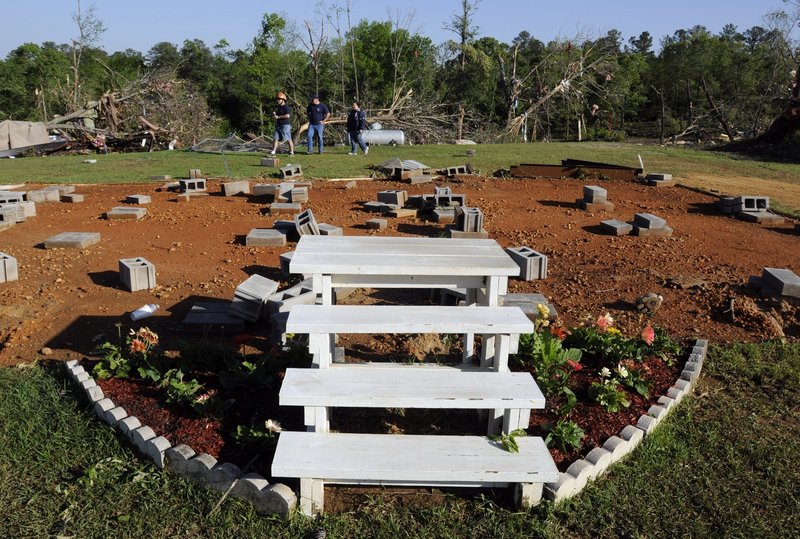 Only stairs and flowers remain Saturday after severe winds tore a mobile home off its lot late Friday night in Boone's Chapel, Ala. A tornado in the area had winds up to 150 mph.