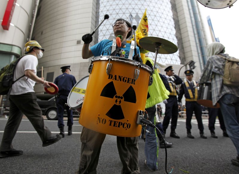 A protester beats a drum in front of the Tokyo Electric Power Co. during an anti-nuclear plant demonstration that drew more than 1,000 people in Tokyo on Saturday.