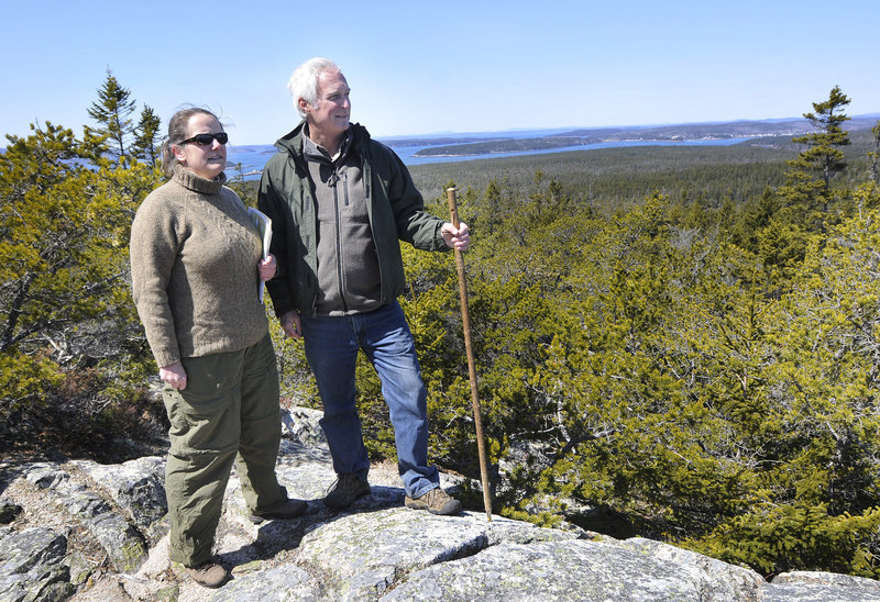 Atop Schoodic Head, Stephanie Clement, conservation director of Friends of Acadia, and Tom Sidar, director of the Frenchman Bay Conservancy, look out over land that may be targeted for development.