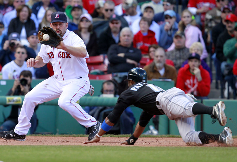 Boston’s Kevin Youkilis, left, takes the throw to nail Toronto’s Corey Patterson trying to steal third base in the eighth inning of an 8-1 Red Sox win at Fenway Park on Sunday.