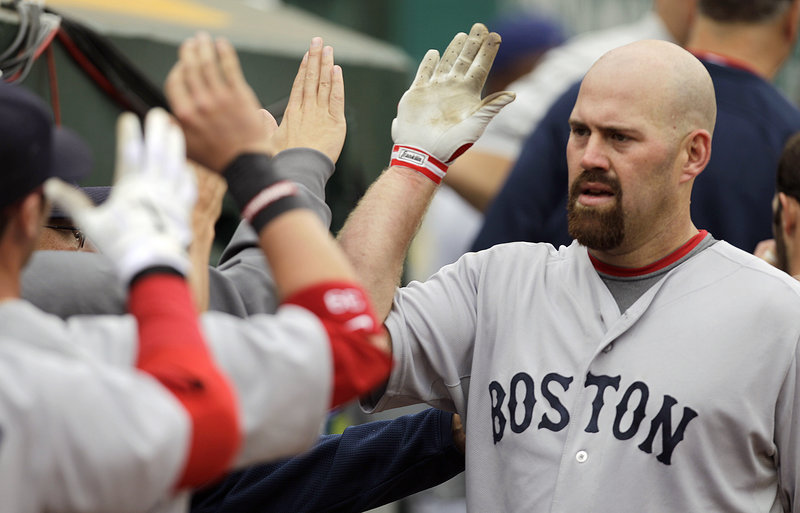 Kevin Youkilis is congratulated by his Red Sox teammates after hitting a home run off Oakland’s Gio Gonzalez in the fourth inning of Boston’s 5-3 win Wednesday.
