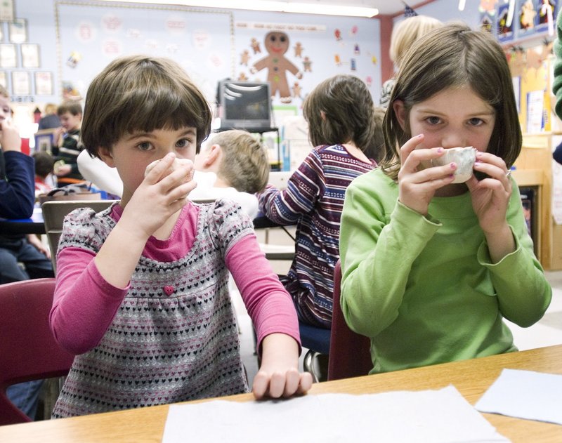 Eleanor Bidwell, 6, and Sophie Galin, 7, sip tea in a lesson based on “Three Cups of Tea” at Hall Elementary School in Portland in 2009. Hall students made their own cups and raised $481.06 for schools in Afghanistan and Pakistan.