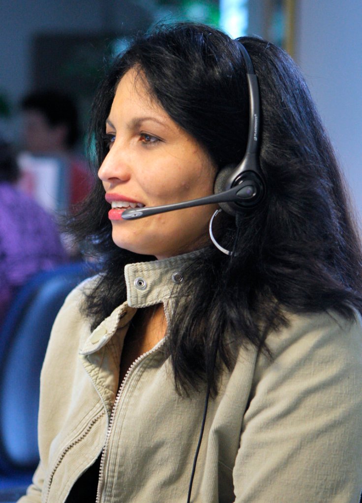 Justina Velez talks with a customer while working in the call center at Wright Express in South Portland. Velez is a bilingual customer service representative, working with customers who speak English or Spanish.