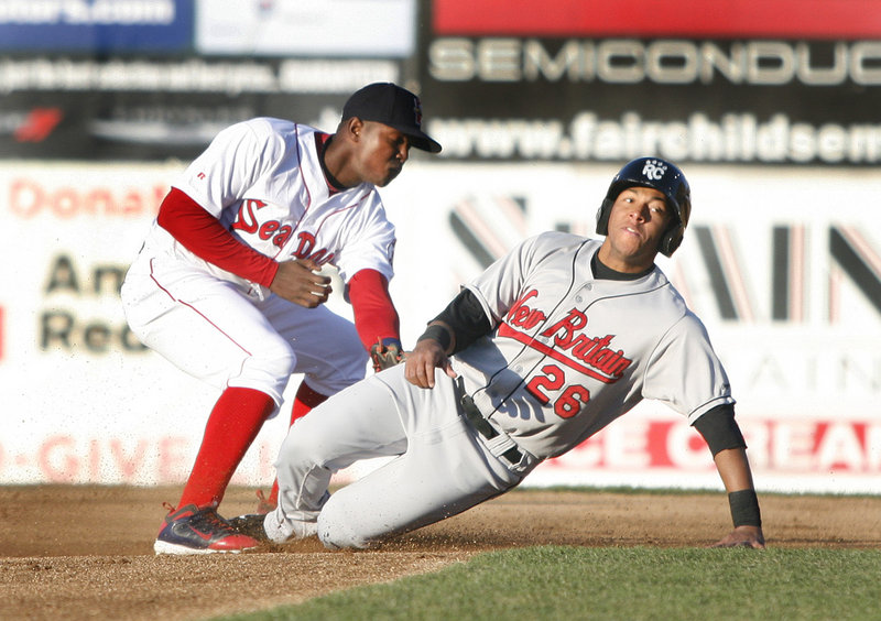 Sea Dogs second baseman Oscar Tejeda slaps a late tag on New Britain's Yangervis Solarte, who steals second Friday night at Hadlock Field. The Rock Cats survived a late Portland rally, holding on for a 9-7 victory.