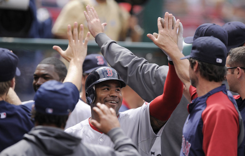 Carl Crawford is greeted by his teammates after hitting his first home run as a member of the Red Sox – a two-run blast in the sixth inning Sunday against the Angels.