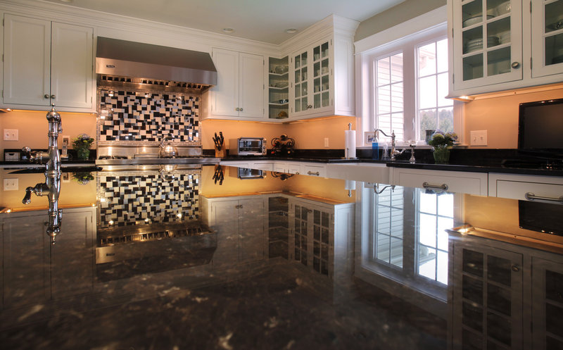 Sarah Steinberg's vocation as a designer who specializes in kitchens and baths is evident in her kitchen, which is reflected in the expansive granite top of the central island. The room is part of an upcoming tour to benefit the Preble Street Maine Hunger Initiative.
