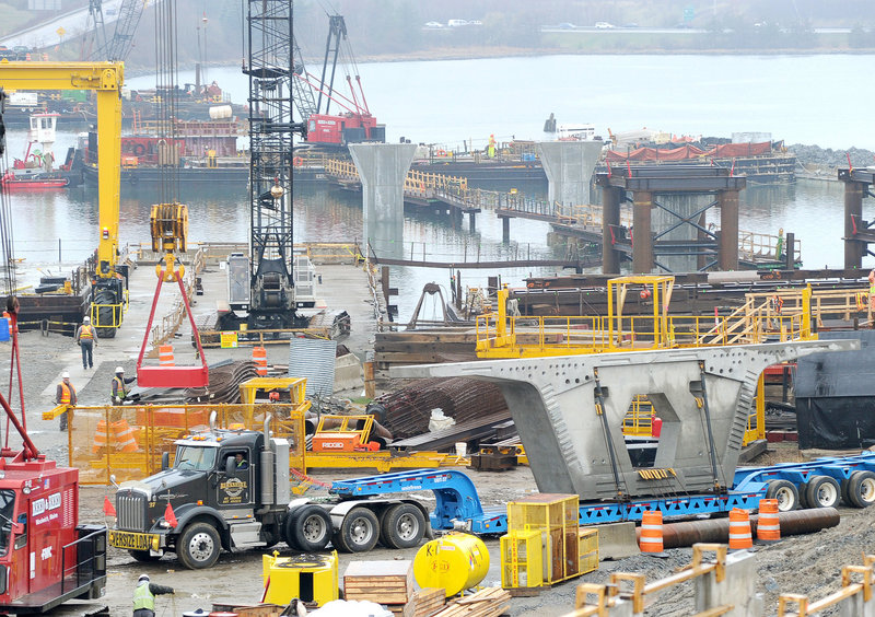 A tractor-trailer delivers a segment of the new Veteran Memorial Bridge to the worksite along the Fore River in Portland on Tuesday.
