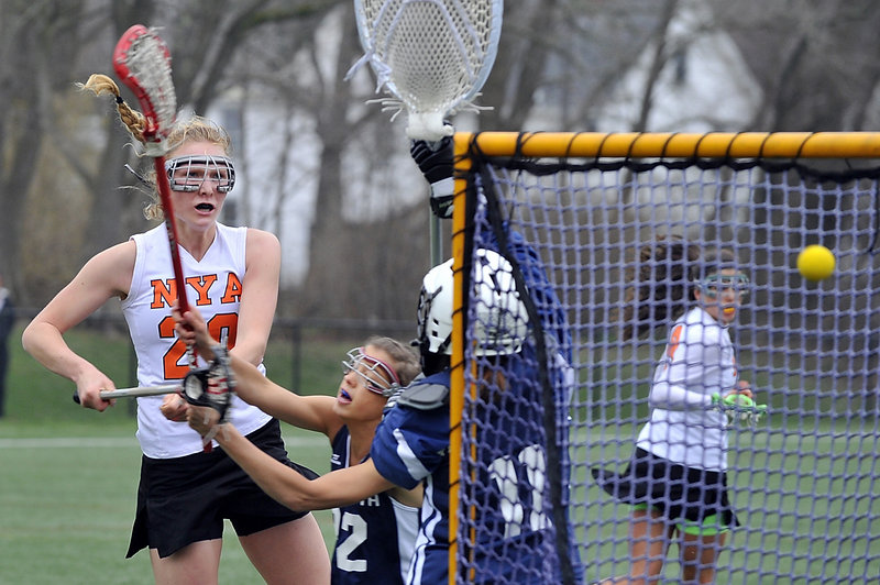 Kate Dilworth and goalie Stephanie Moulton of Yarmouth combine to knock away a second-half shot by Lilly Wellenbach of North Yarmouth Academy.