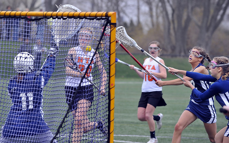 Lilly Wellenbach of NYA breaks away Tuesday for one of her three goals in the 16-9 loss to Yarmouth. The Yarmouth goalie is Stephanie Moulton as defenders Kate Dilworth and Olivia Harrison move in. No. 16 for NYA is Katie Cawley.