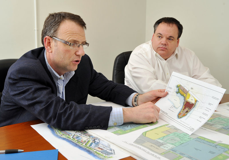 Bill Ryan Jr., left, and Jon Jennings, two co-owners of the Red Claws, examine details of a proposed arena.