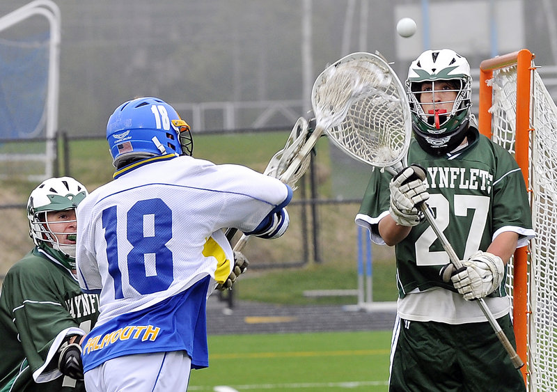 Willy Sipperly of Falmouth takes a shot stopped by Will Hallette of Waynflete as Don Wiener of the Flyers moves in Wednesday. Sipperly scored five goals in a 17-6 victory.