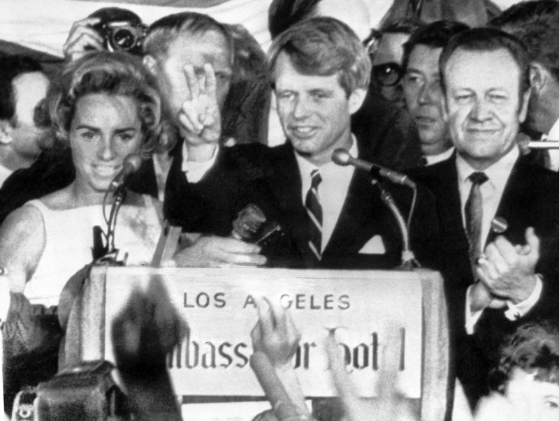 Sen. Robert F. Kennedy holds up two fingers in a victory sign as he talks to campaign workers at the Ambassador Hotel in Los Angeles before he was shot on June 5, 1968.
