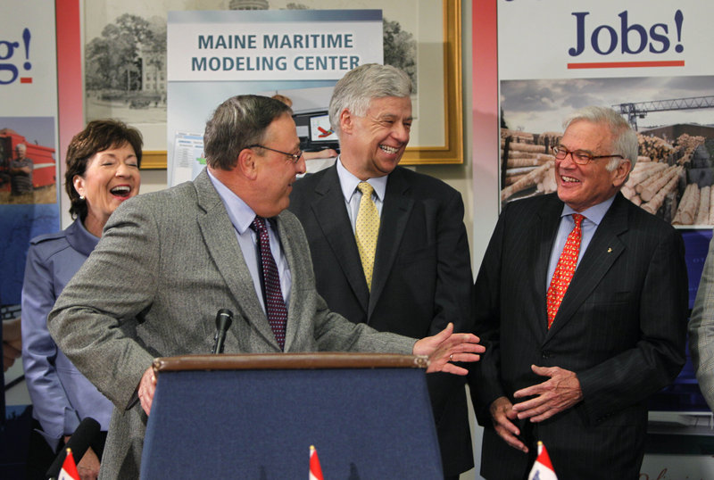 Gov. Paul LePage, at podium, jokes with American Bureau of Shipping chairman Robert Somerville, far right, Thursday during a news conference. Maine’s Sen. Susan Collins and Rep. Michael Michaud look on.