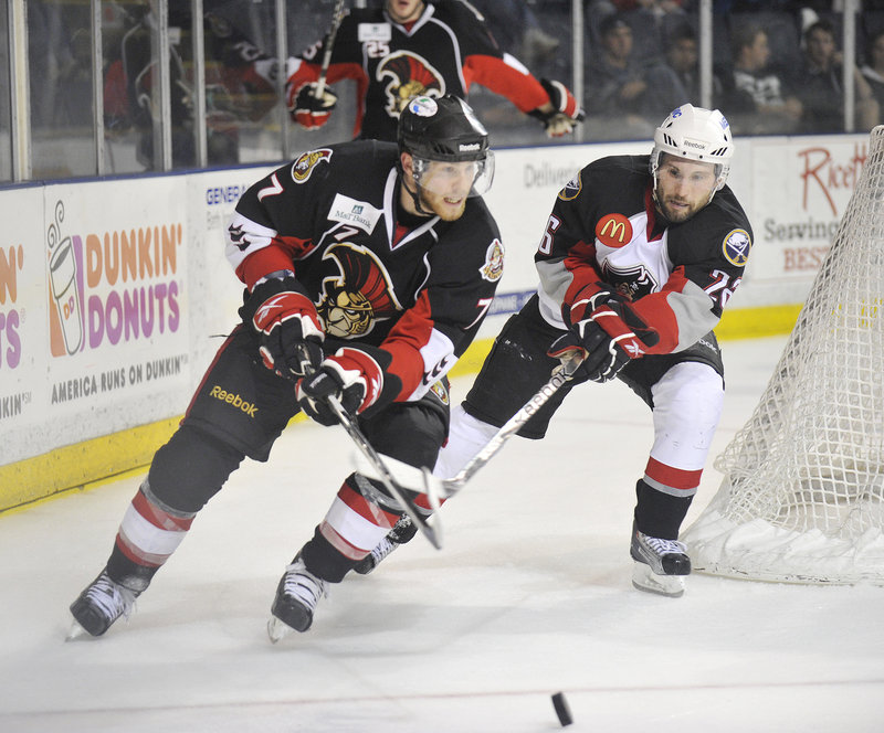 Geoff Kinrade of the Senators, left, circles the net while chased by Portland’s Brian Roloff during Binghamton’s 5-3 victory Thursday night. The Senators head home with a 2-0 lead in the best-of-seven playoff series.