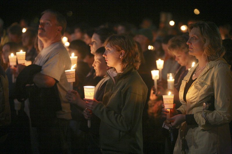 A crowd estimated at more than 1,000 people listens to speakers at the candlelight vigil for Krista Dittmeyer at the Stevens Brook Elementary School in Bridgton on Thursday night.