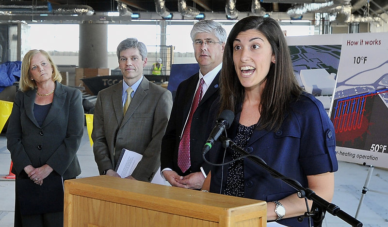 Christa Fornarotto, right, of the Federal Aviation Administration, praises the energy-saving geothermal heating and cooling system going into the Portland International Jetport. Other speakers, from left, are U.S. Rep. Chellie Pingree, jetport manager Paul Bradbury and Portland Mayor Nick Mavodones.