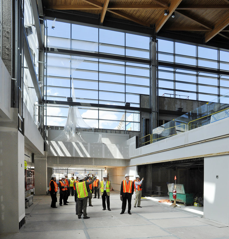 A group of officials gets a look at upgrades under way at the Portland Jetport on Friday. The improved terminal will open in October.