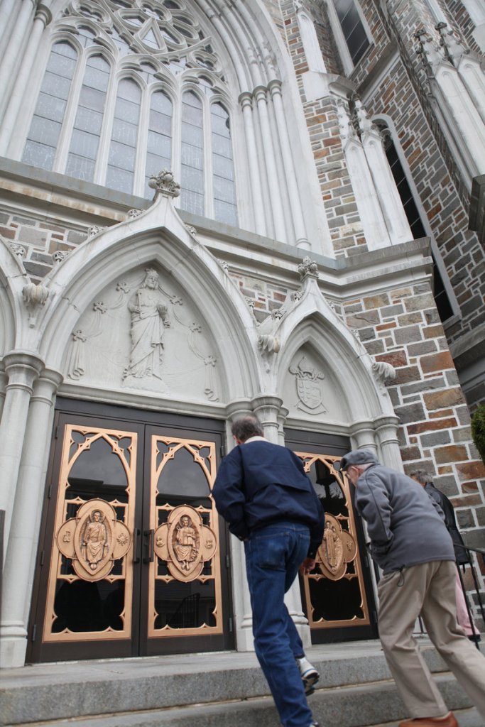 Brian LeBlanc of Lunenburg, Mass., and his father, Leo, of Leominster, enter St. Cecilia Church in Leominster, Mass. The Archdiocese of Boston launched an ad campaign during Lent to encourage parishioners to come to church.